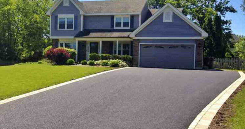 A perfectly paved driveway in front of a two-story home