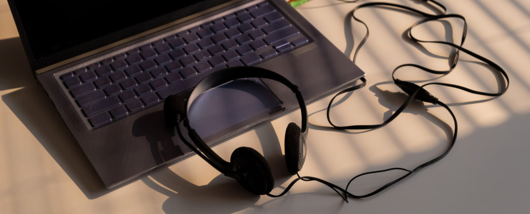 Headphones connected to a laptop computer.