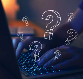 Fingers on laptop keyboard with superimposed question marks all over the image