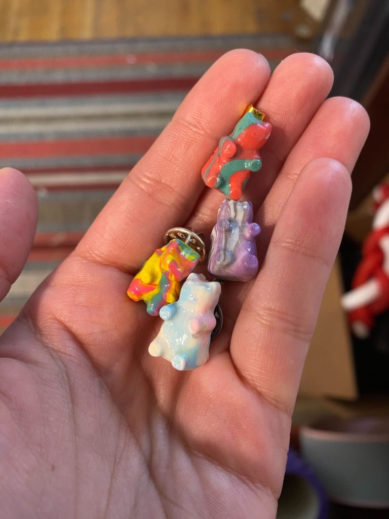 Four multi-colored resin gummy bears, each attached to a keychain.