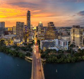 A panorama of the Austin, Texas skyline at sunset.