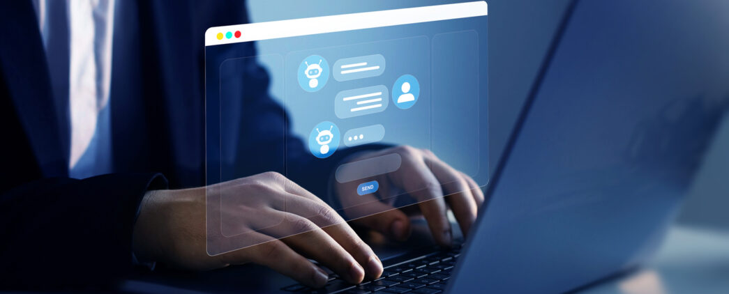 A person sitting at a computer chatting with someone on messenger. The chat looks holographic coming off the screen.