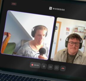 A laptop screen displaying the virtual podcast recording for this episode. Devon and Kristen are visible in separate video windows on the laptop.